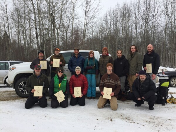 Participants in Alberta's first Wildlife Track & Sign Certification Evaluation. Those that demonstrated sufficient skill were awarded certifications of varying levels. They pose with their certificates.